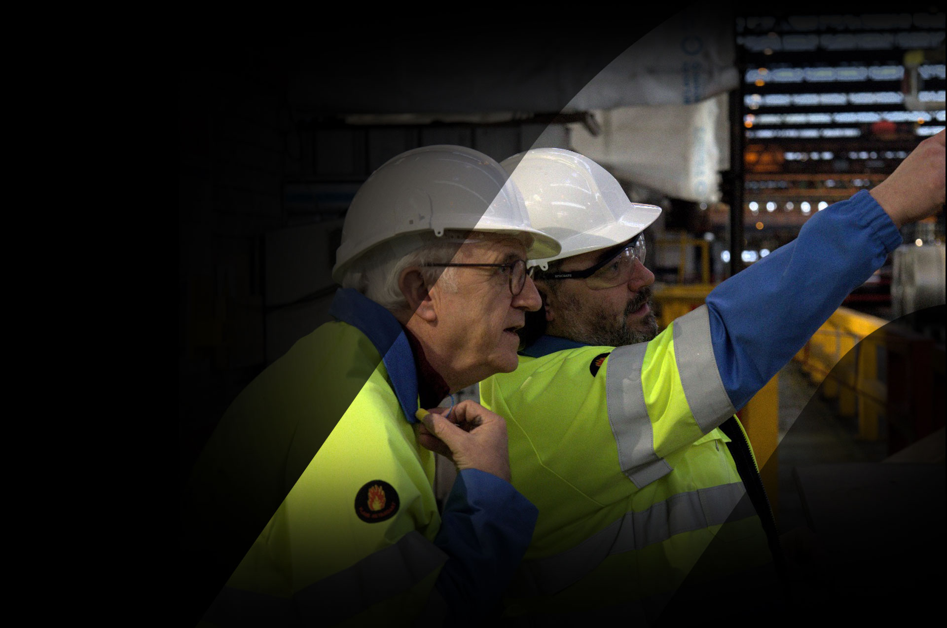 Factory scene with 2 men with hard hats
